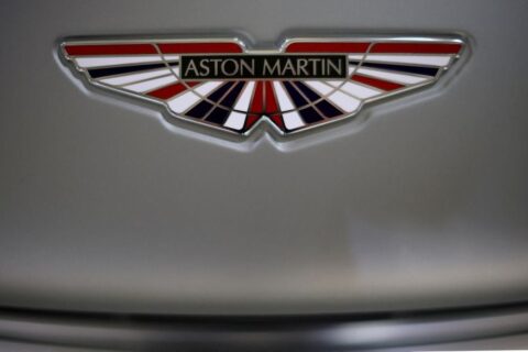 The Aston Martin logo is seen on a V12 Vantage car at the company’s factory in Gaydon, Britain, March 16, 2022. Picture taken March 16, 2022. REUTERS/Phil Noble/File Photo